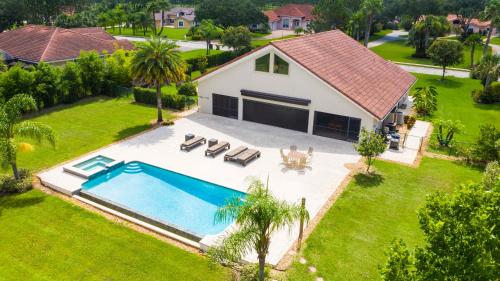 an aerial view of a house with a swimming pool at SWISS 105 - Lake Olsen in Clermont