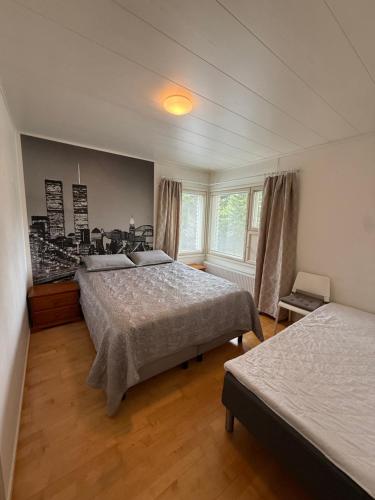 a bedroom with two beds and a window at Jalokivi in Lappeenranta