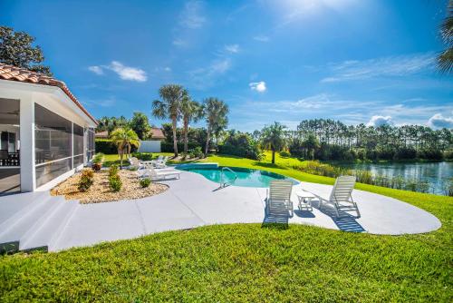 a patio with chairs and a swimming pool at SWISS 66 - Lake Denise in Clermont