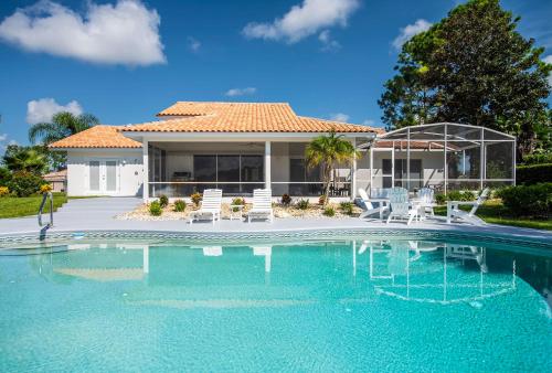 a swimming pool in front of a house at SWISS 66 - Lake Denise in Clermont