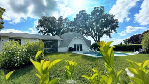 a house with a swimming pool in a yard at Sumner Lake House 2B in Clermont