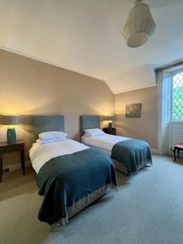 a bedroom with two beds and a window at Number 6 Narrow Water Castle in Warrenpoint