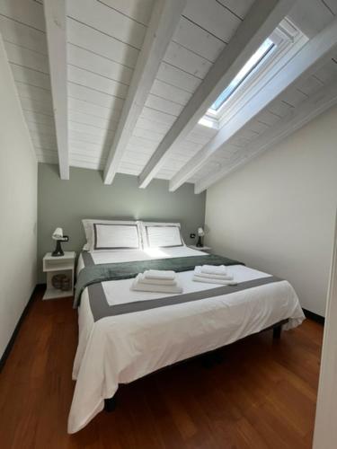 a bedroom with a large bed in a white room at Studio21 Monza in Monza