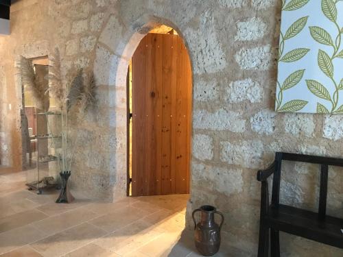a hallway with a wooden door in a stone wall at La Mouline de Belin in Lectoure