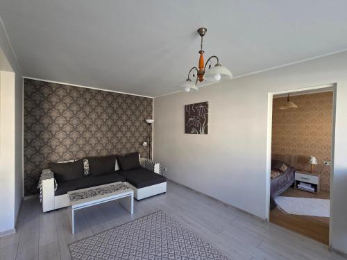 a living room with a couch and a table at Apartment Südalinnas in Haapsalu