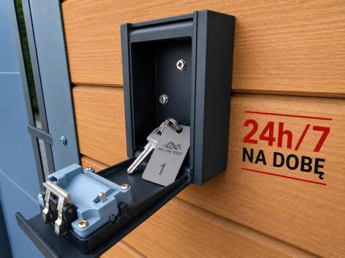 a lock on a door with a tag on it at ECO HOUSE in Szypliszki