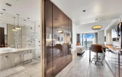 a bathroom with a shower and a sink and a kitchen at Palms Place Condo Hotel & Casino in Las Vegas