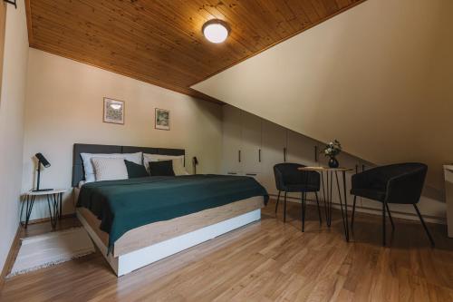 a bedroom with a bed and a table and chairs at Apartman Susilova Slavkov in Slavkov u Brna