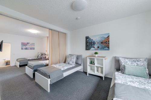 a bedroom with two beds and a couch at Jans 4 Personen Work Apartment mit Küche P WLAN Code NRW Veltins Arena in Herten
