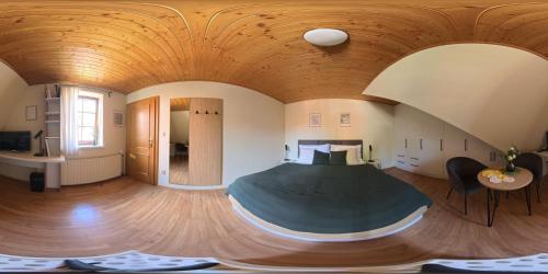 a bedroom with a bed in a room with a wooden ceiling at Apartman Susilova Slavkov in Slavkov u Brna