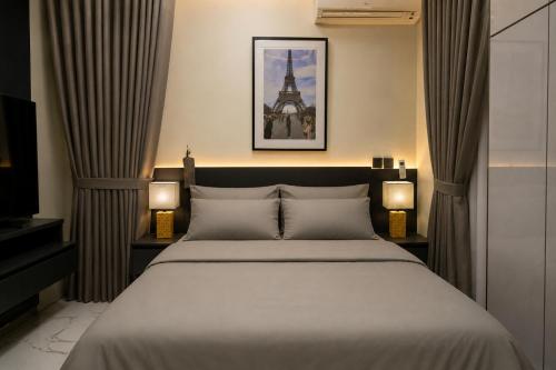 a bedroom with a large bed with two lamps at The COZY CREST in Akure