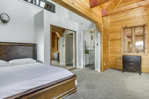 a bedroom with a bed and a wooden wall at Hiking, Wineries & More! Mtn-View Gem in Tehachapi in Tehachapi