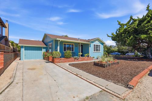 a blue house with a driveway at The Eastman House in Santa Cruz