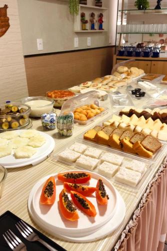a buffet with many different types of food on a table at Pousada São Luiz in Aracaju