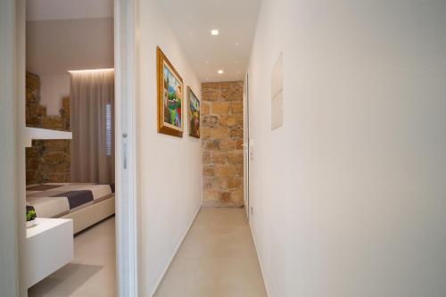 a hallway leading to a bedroom in a house at DaiRa 103 Luxury Suite sulle Mura di Cefalù in Cefalù