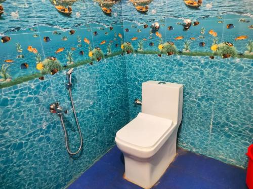 a bathroom with a toilet and a shower in the water at Mangrove Village Inn in Kāsarkod