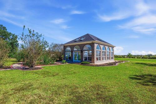 a gazebo in the middle of a grass field at Escape at the SK in Huntsville
