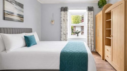 a bedroom with a bed and a window at Modern Apartment with Garden in Rothesay