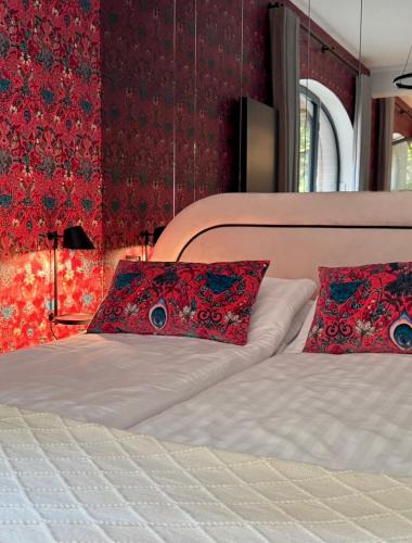 a bedroom with a bed with two pillows on it at Luxury Art Apartment Centrum Poznań Plac Wolności in Poznań