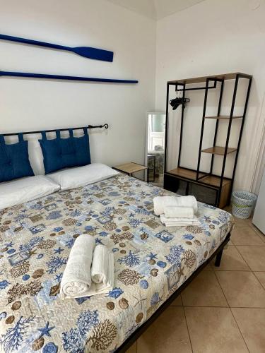 a bedroom with a bed with towels on it at Cabina Da Mare in Marettimo