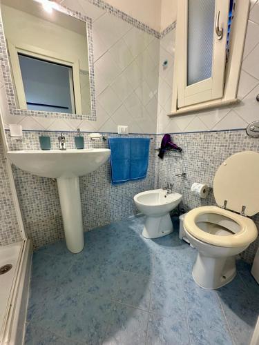 a bathroom with a sink and a toilet and a mirror at Cabina Da Mare in Marettimo
