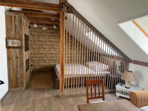 a room with a crib with a bed in it at Lake House Siófok in Siófok