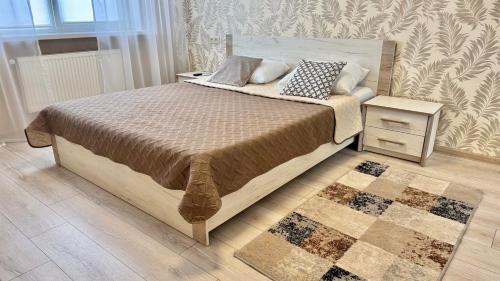 a bedroom with a large bed with a nightstand and a bed sidx sidx sidx at Sea garden apartment in Kryzhanivka