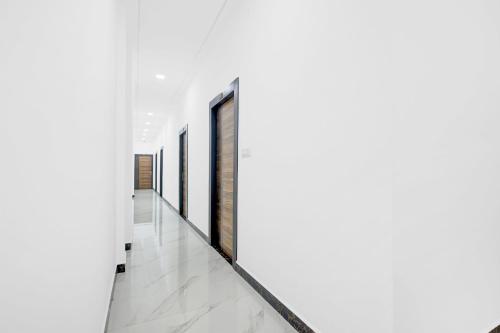 a hallway with white walls and a row of windows at Super Hotel O Antilia in Gorakhpur