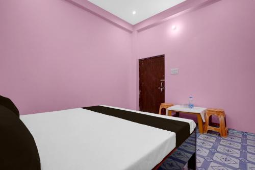 a bedroom with a white bed and a table at Hotel O A2Z Hotel in Lucknow