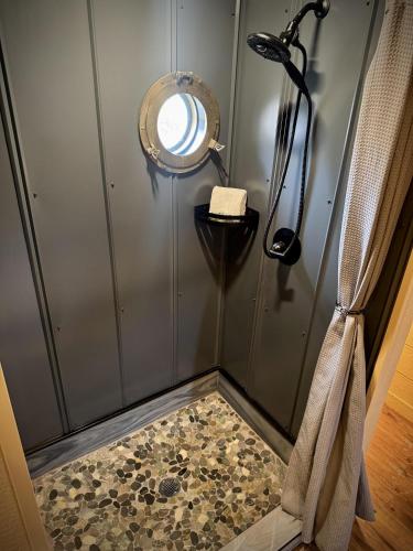 a shower with a mirror and a shower floor at "The 19th Hole" Luxury Treehouse w Golf Views & Private 20ft Slide - 10 Miles from Dollywood in Sevierville
