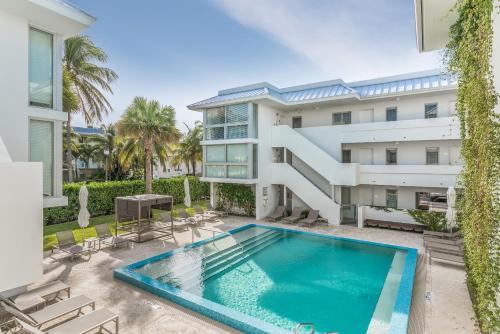 an exterior view of a building with a swimming pool at Beach Haus Key Biscayne Contemporary Apartments in Miami