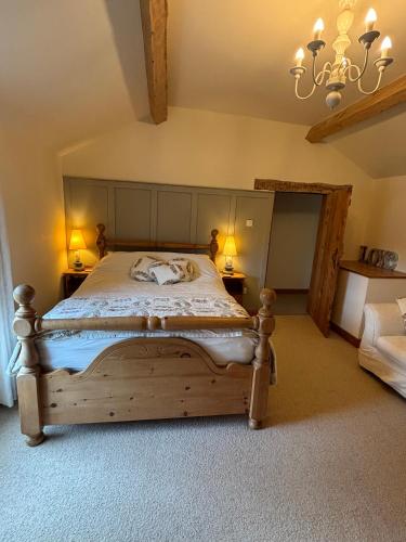 a bedroom with a wooden bed with two lamps at Southview Farm, Hambleton, Poulton-Le-Fylde in Hambleton