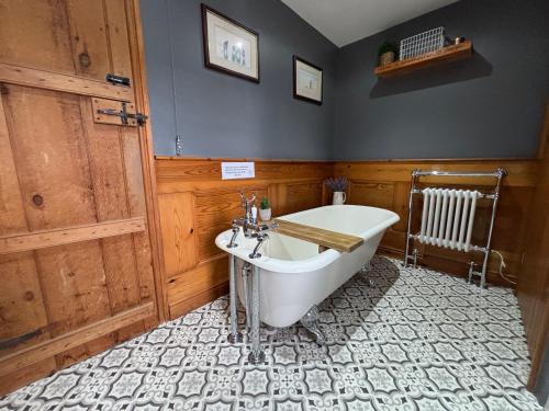 a bathroom with a tub and a sink at Southview Farm, Hambleton, Poulton-Le-Fylde in Hambleton
