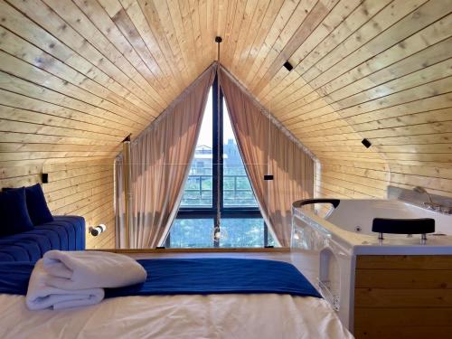 a room with a bed and a sink and a window at Les Pavillons D'Ehden in Ehden