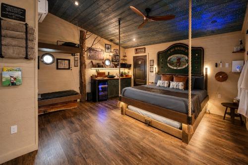 a bedroom with a swing bed in a room at "The 19th Hole" Luxury Treehouse w Golf Views & Private 20ft Slide - 10 Miles from Dollywood in Sevierville