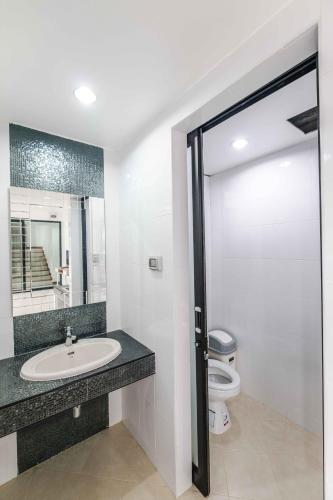 a bathroom with a sink and a toilet at Don Muang Hotel in Bangkok