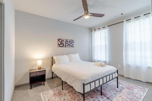a bedroom with a bed and a ceiling fan at Super Central 1BD Workers Paradise in Charlotte