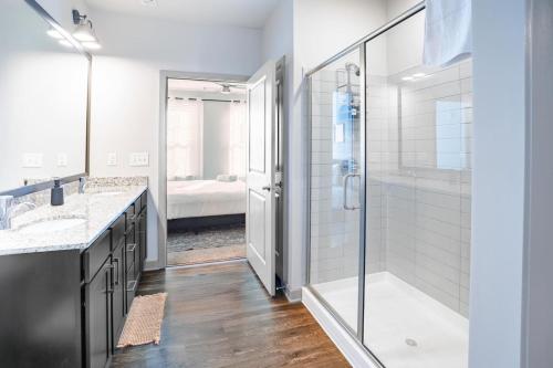 a bathroom with a walk in shower and a glass shower stall at Stylish, Comfortable 2BD Abode near DT Matthews in Charlotte