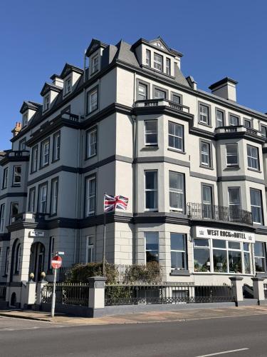 a large building with an american flag in front of it at West Rocks Hotel in Eastbourne