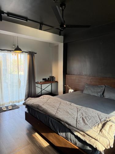 a bedroom with a large bed and a window at Terrace By Opal in Barābhīta