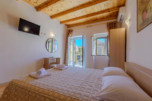 a bedroom with a bed with two towels on it at Corfu Spanos House in Sokraki in Sokrákion