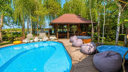 a swimming pool and a gazebo in a yard at Дом на берегу 1dom club in Protsev