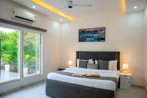 a bedroom with a large bed and a large window at Luxury Haven Stay in Noida