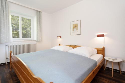 a bedroom with a large bed and a window at Gut Staberhof Staberholz in Staberdorf
