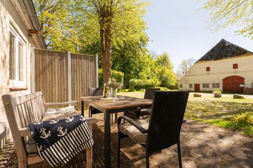a patio with a wooden table and chairs at Gut Staberhof Staberholz in Staberdorf