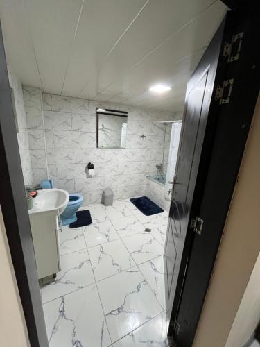 a white bathroom with a sink and a toilet at Mtskheta Oasis Garden in Mtskheta