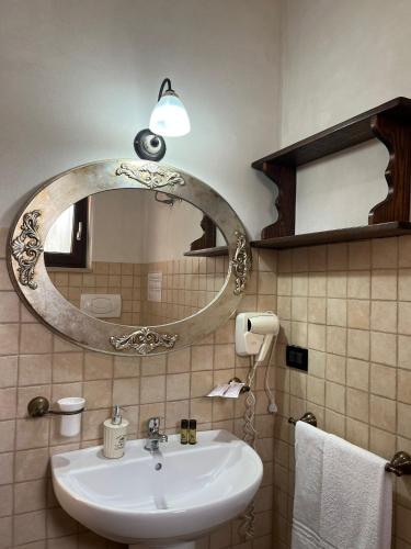 a bathroom with a sink and a mirror at Masseria Tolla in Ostuni
