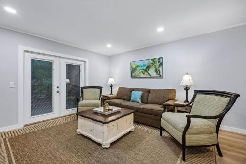 a living room with a couch and a table and chairs at 8A Amelia Landings Condo in Fernandina Beach