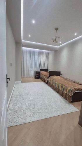 a large room with two beds and a window at Jasmin Park in Baku
