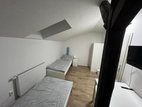 a small room with two beds in it at Gemütliches kleines Zimmer in Jerrishoe